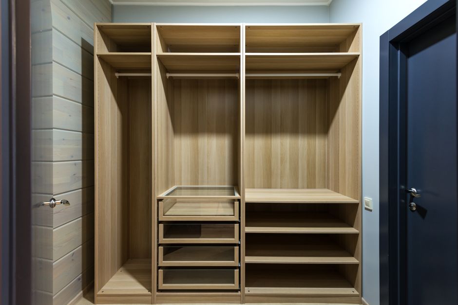 Modern wooden closet drawers built into a wall unit