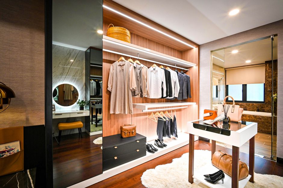 Luxurious modern custom walk-in closet with elegant lighting and wooden shelving